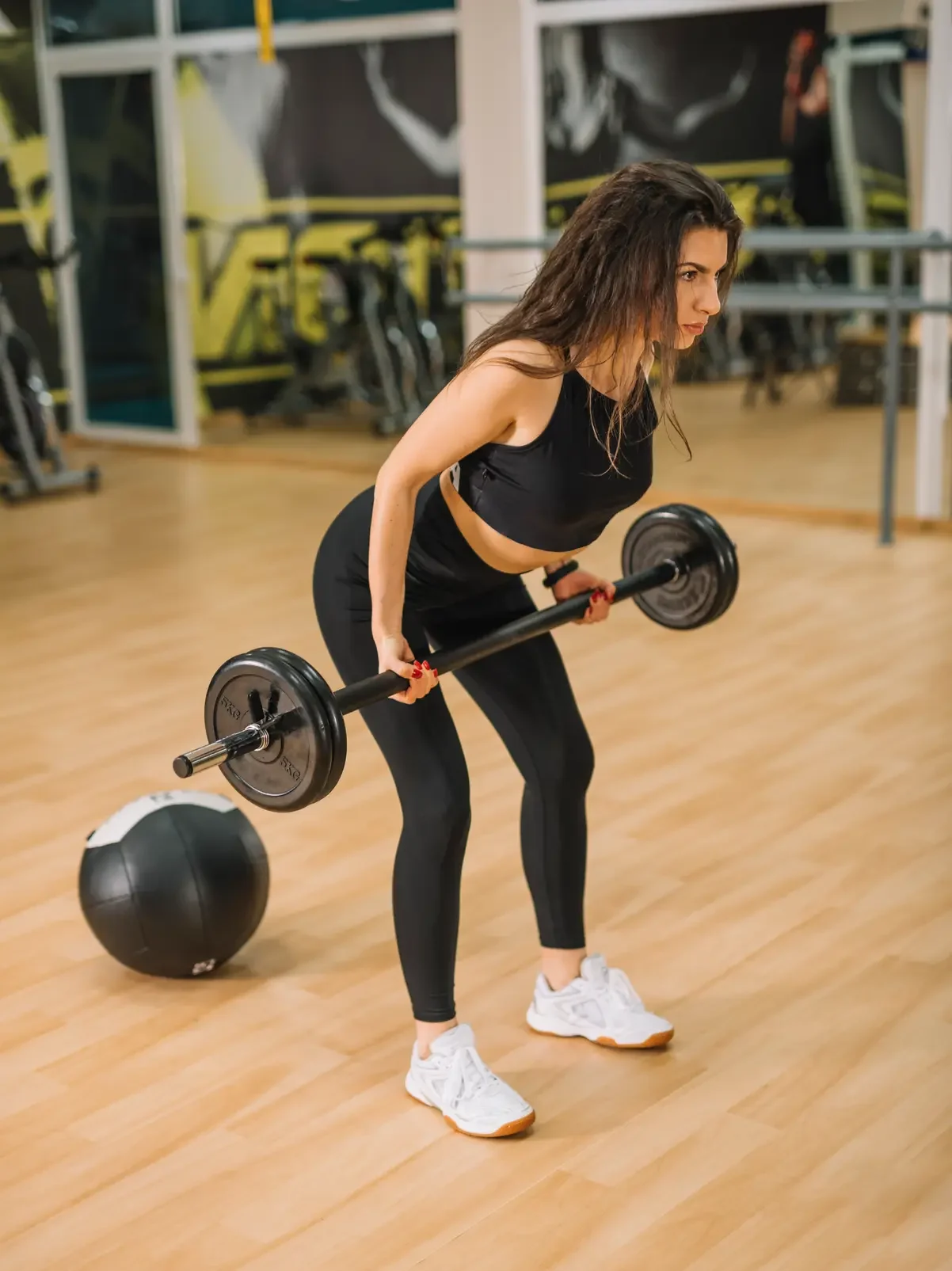 athletic-young-woman-training-with-barbells-gym